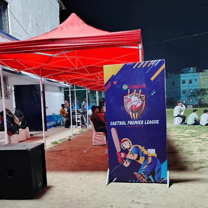 Castrol Premier League Season 2 standee beside the floodlit Harvard House Sports ground, Tangra