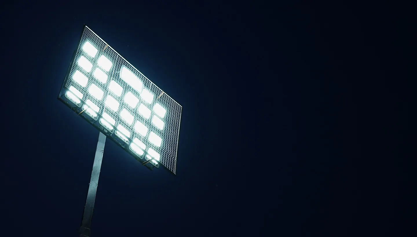 Floodlight tower lit at night at Harvard House Sports