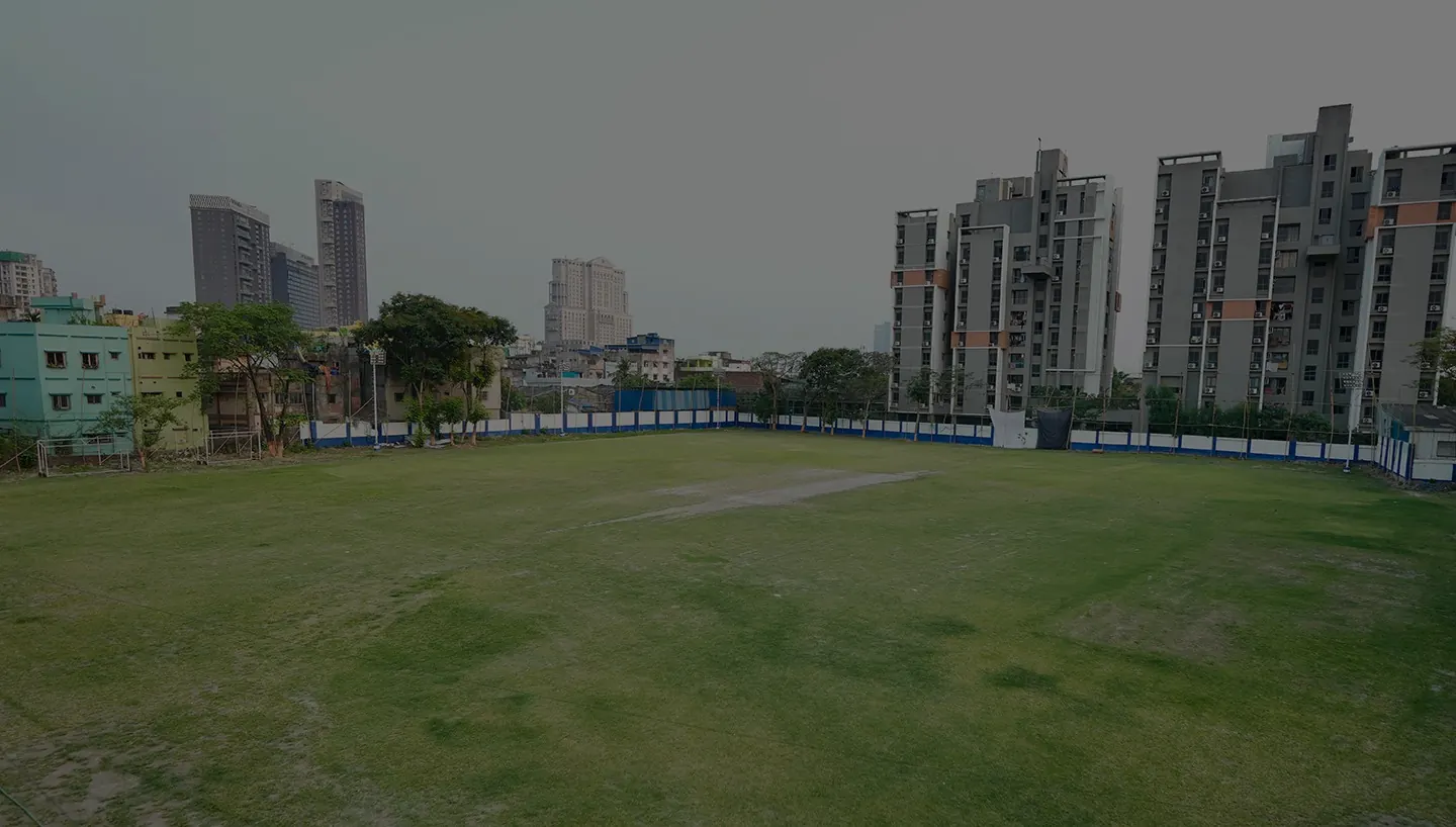 Harvard House Sports cricket ground with the Kolkata skyline behind