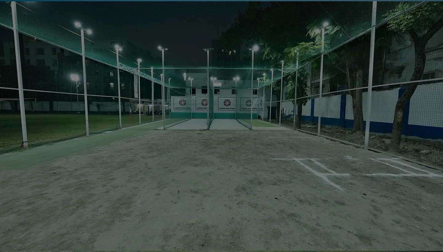 Harvard House Sports practice nets lit at night