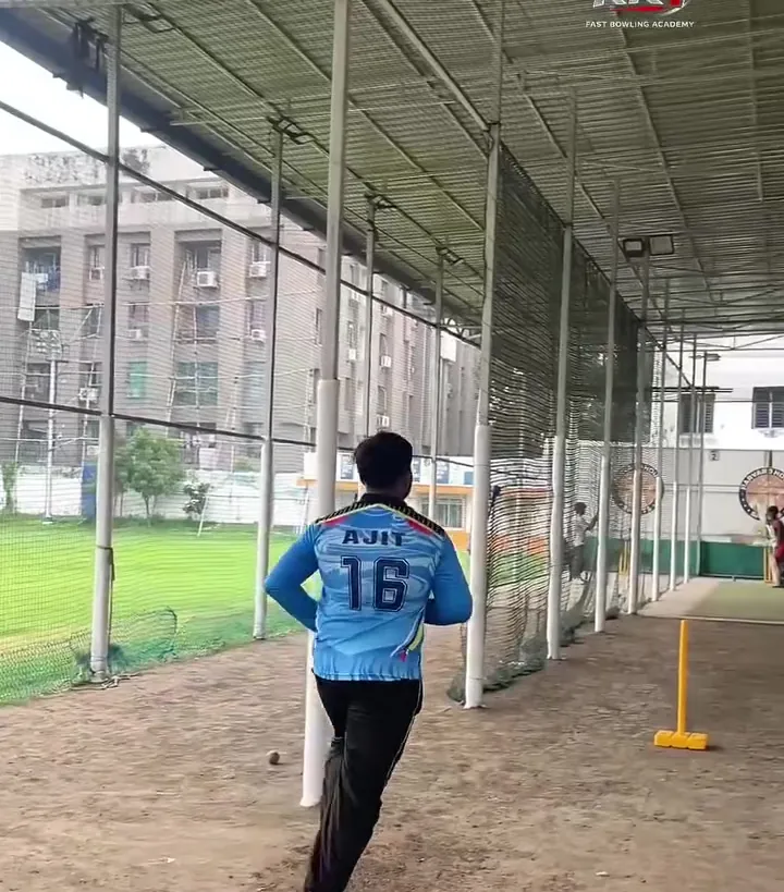Bowler walking back to his mark in the covered nets