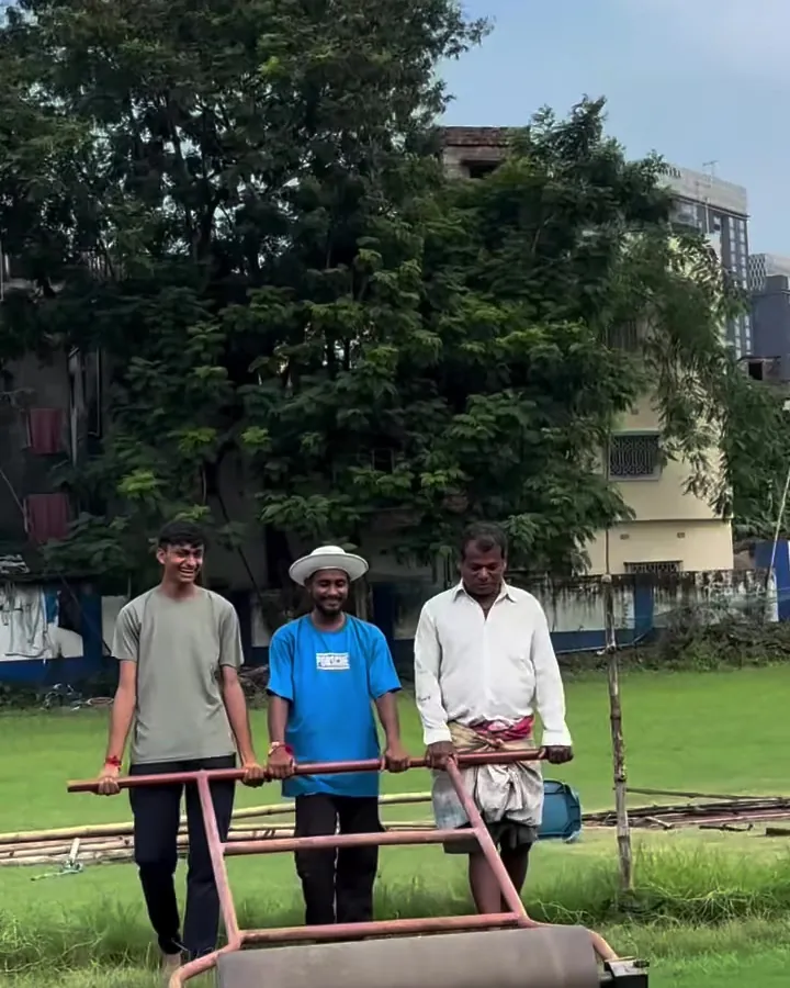 Ground staff rolling the pitch with the heavy roller